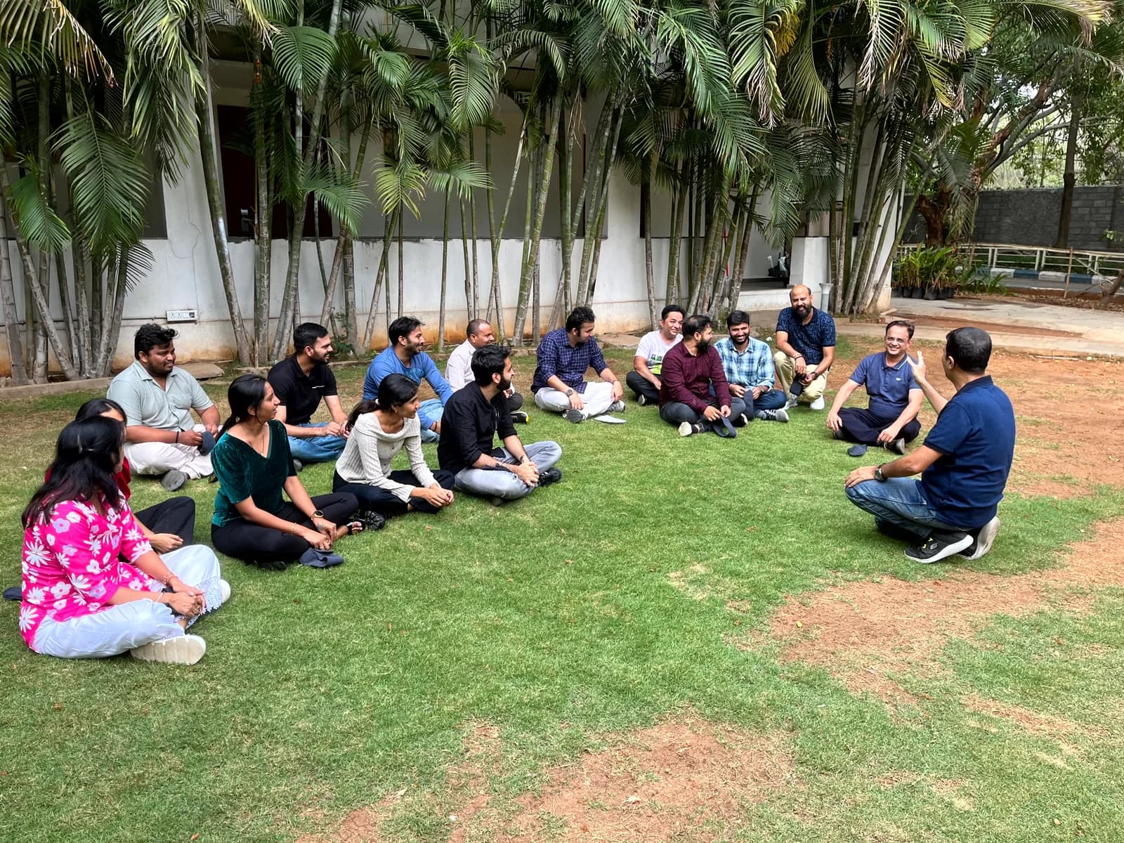 FusionFoundry team sitting in a circle on the lawn during an outdoor session