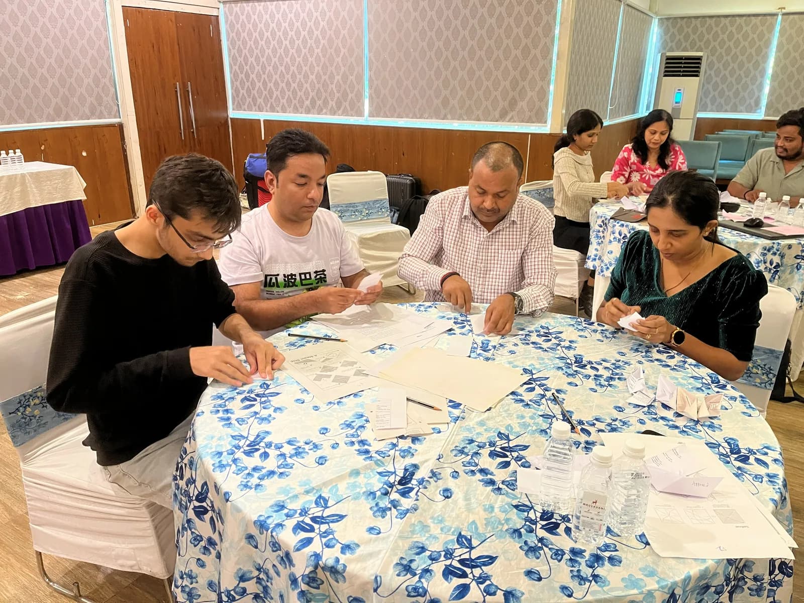 FusionFoundry team working through a hands-on exercise at a table