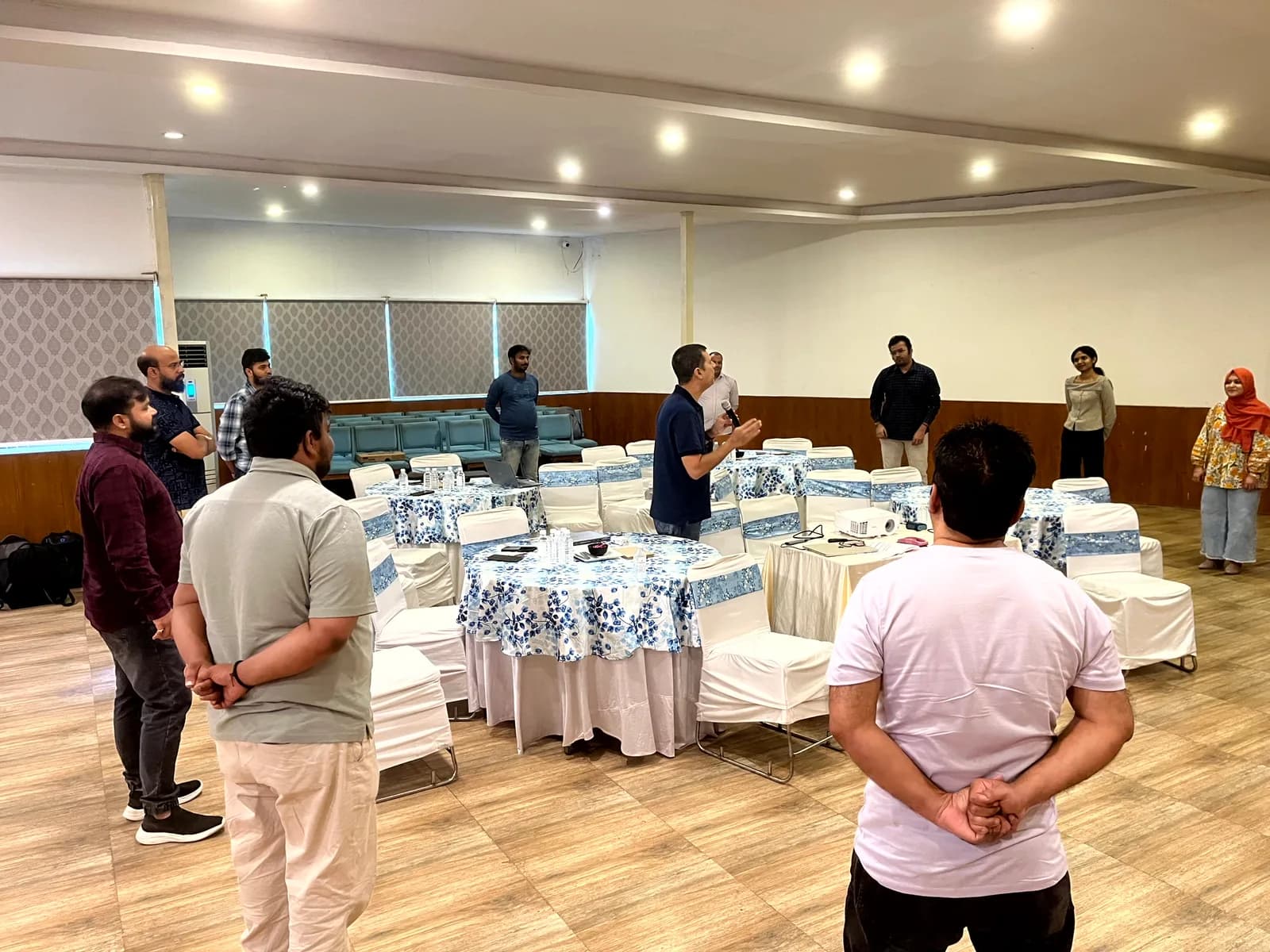 FusionFoundry team spread across a workshop room during a group activity